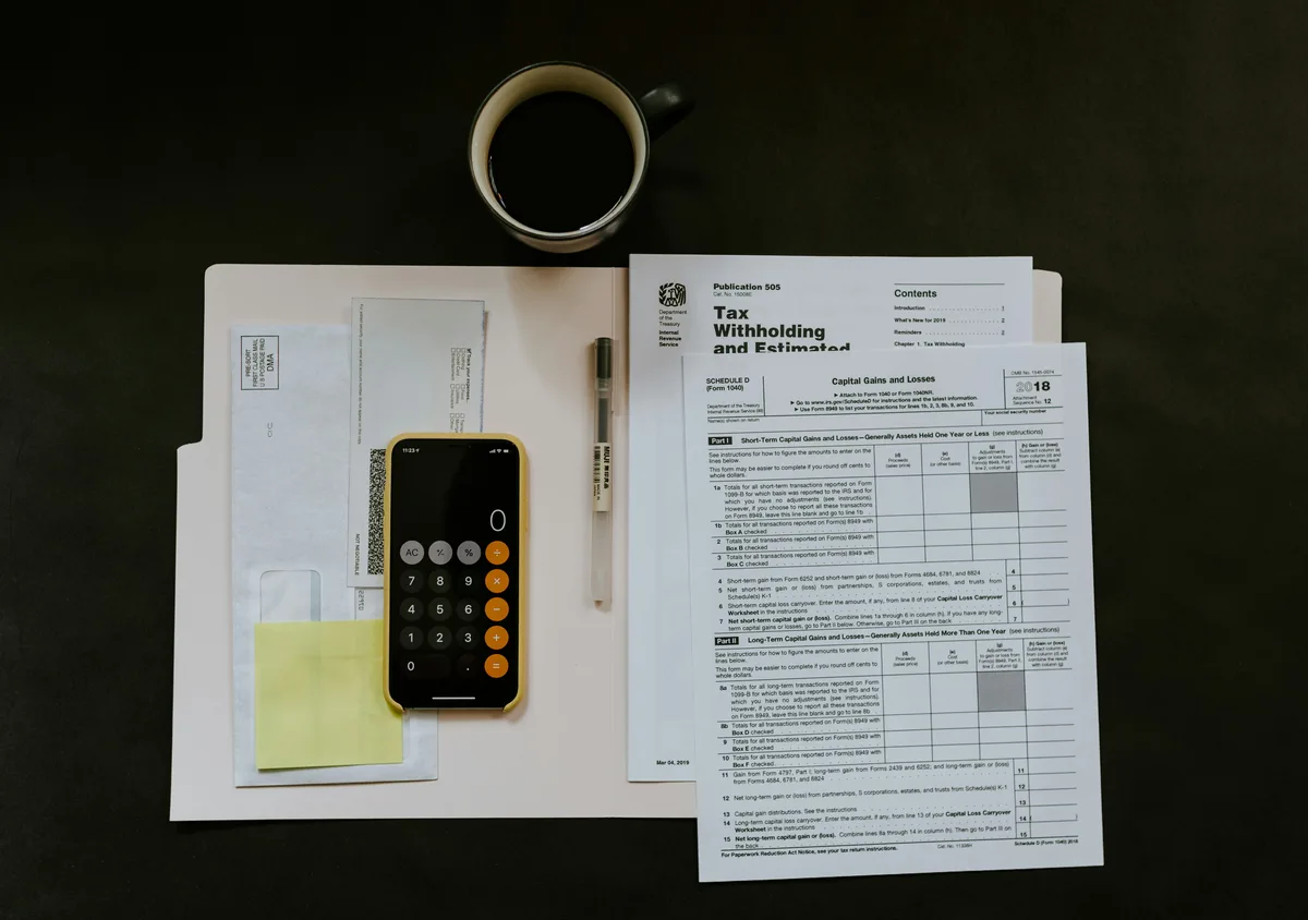 Calculator and financial documents used to estimate a child support obligation