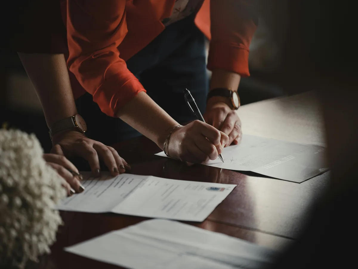 Parent signing legal paperwork to modify a child support order